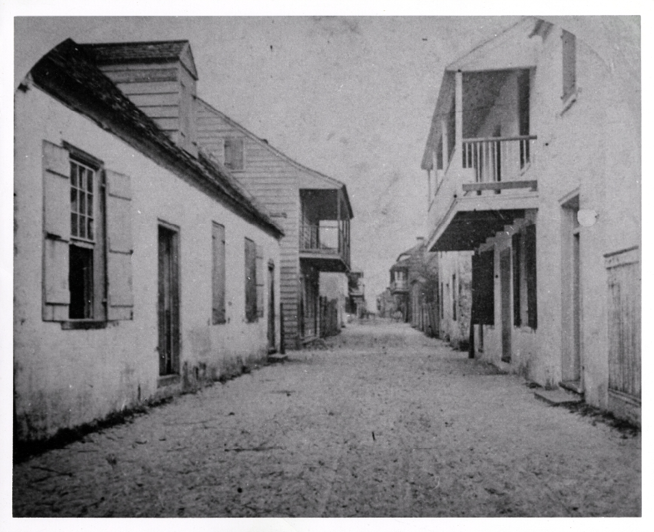 A black and white photograph from a stereograph of St. George Street featuring both the Benet House and Store.